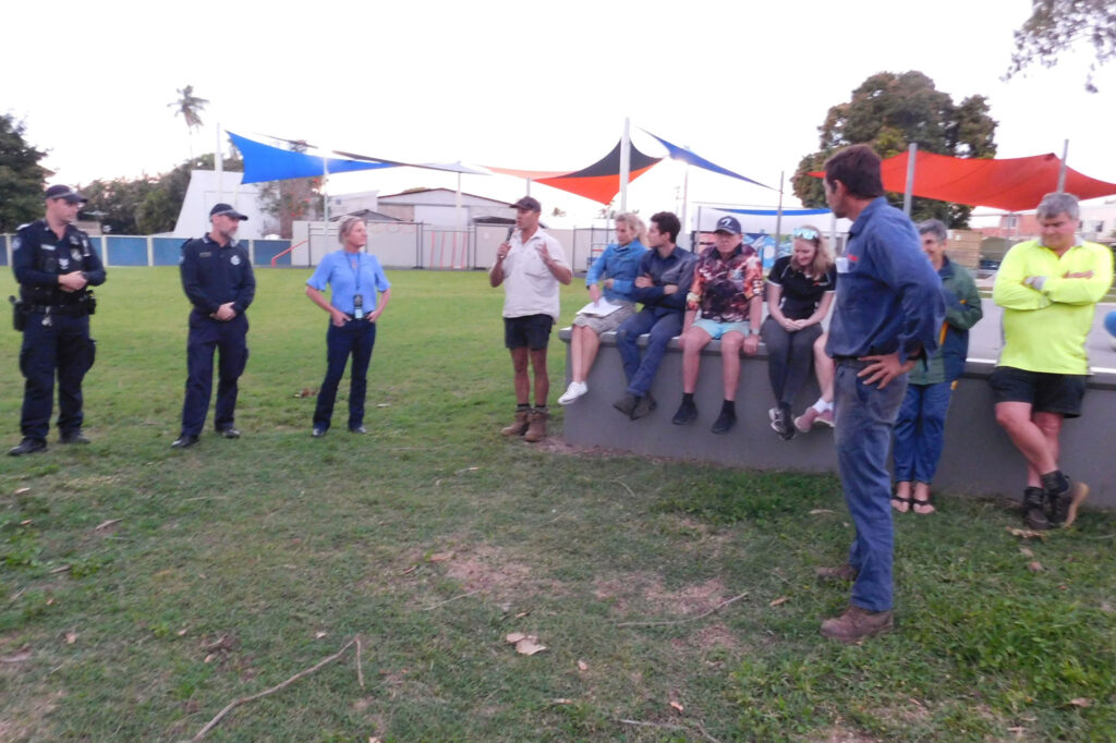 Mark Vass speaks to the crowd watched by Burdekin District Police Officers