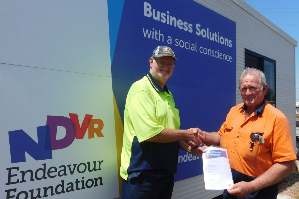 Kevin Woods of Home Hill receives his recognition certificate for 35 years of service to the Endeavour Foundation